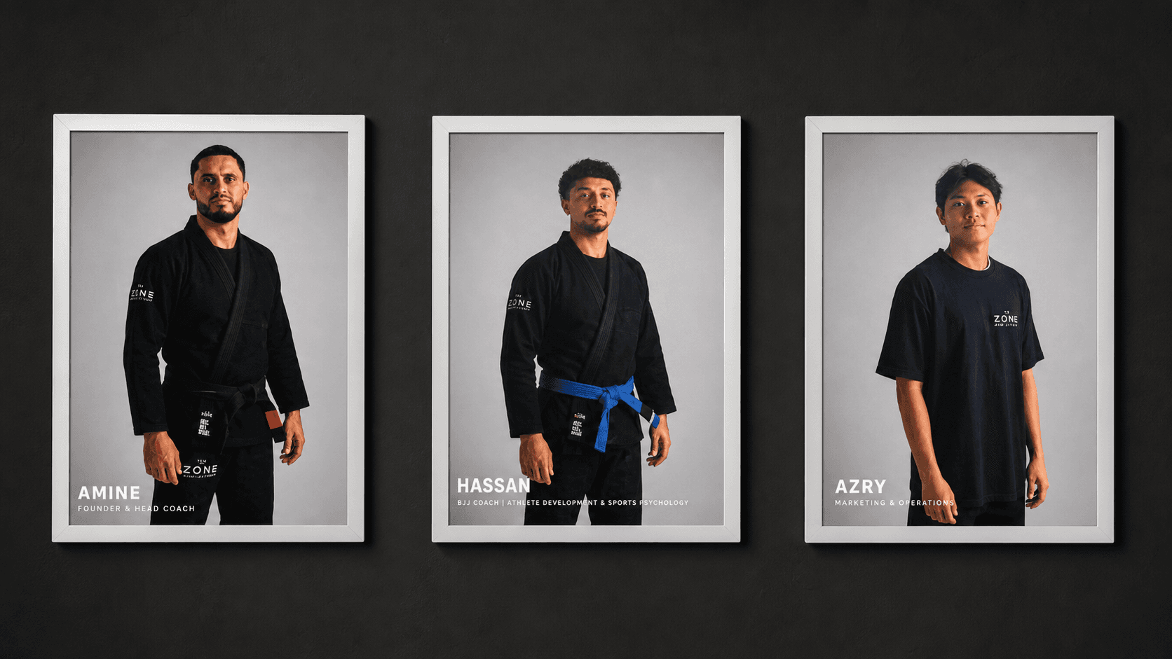 Professionally framed portraits of academy team members on a black wall
